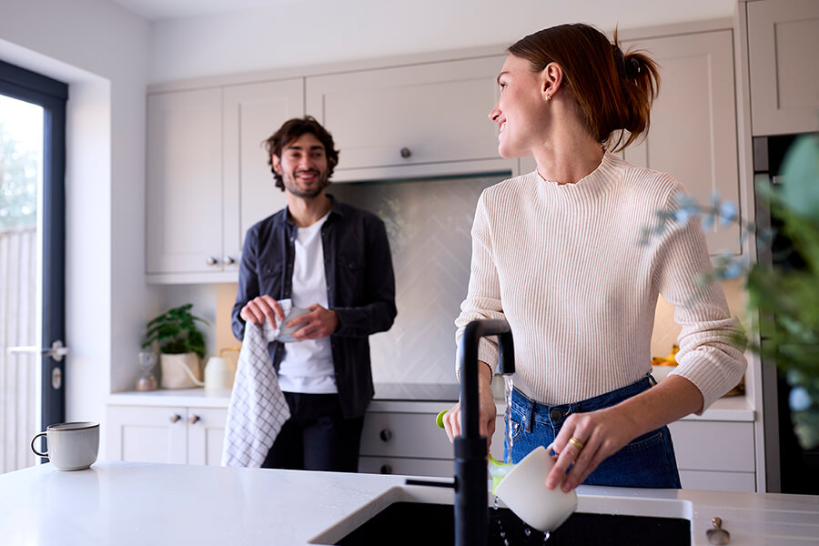 Couple at home in kitchen with woman doing washing 2023 01 18 01 48 31 utc
