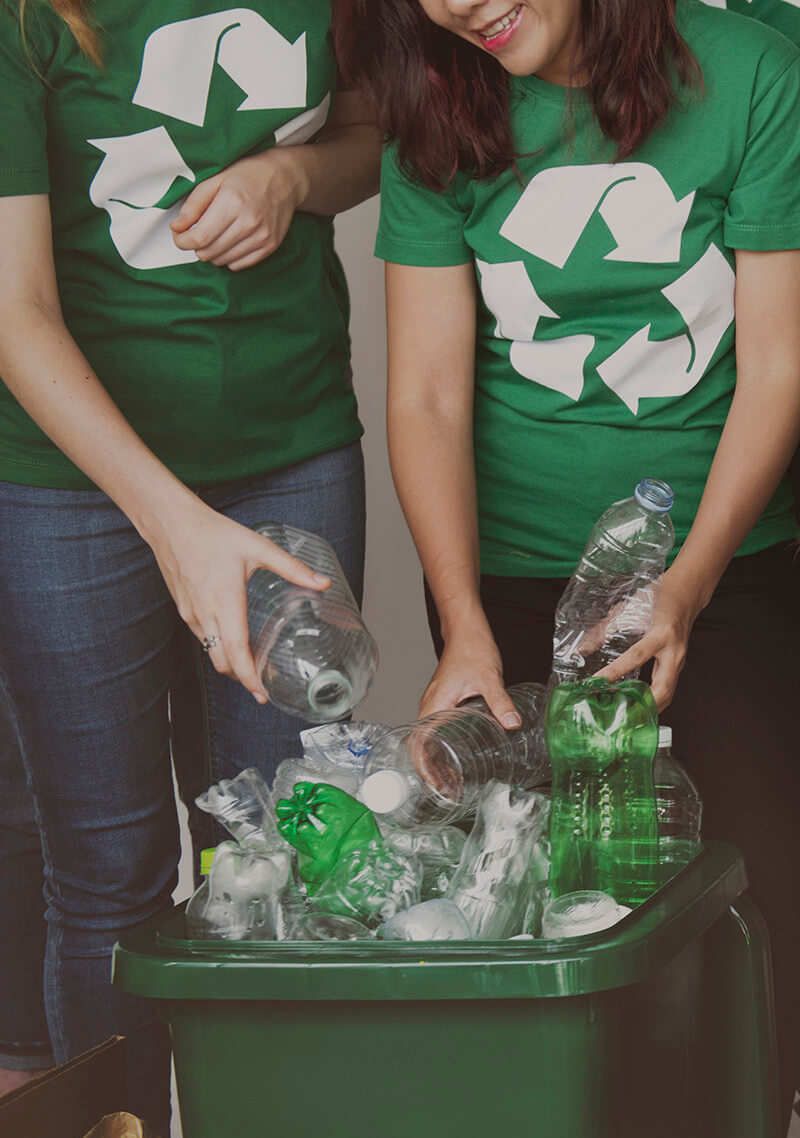 People recycling plastic bottles